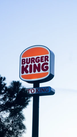 a burger king sign is lit up outside