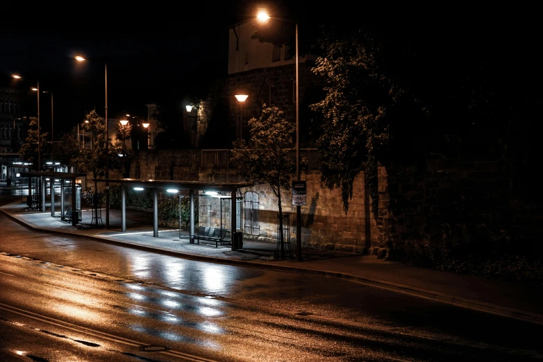 a lit up bus stop sitting at night