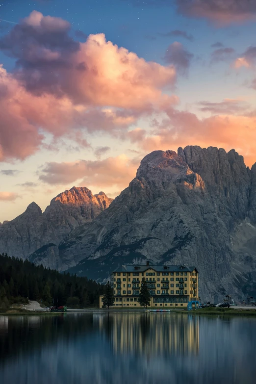 the beautiful sky at night is reflecting the mountains