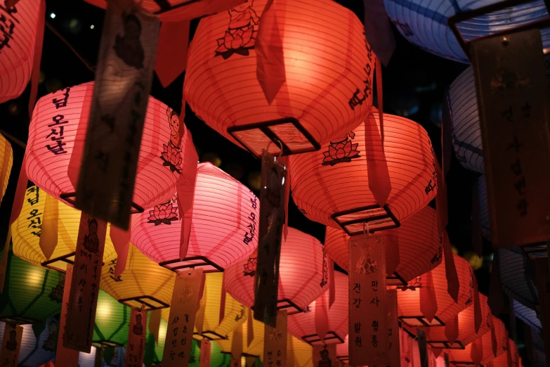 large lit lanterns in different colors are displayed