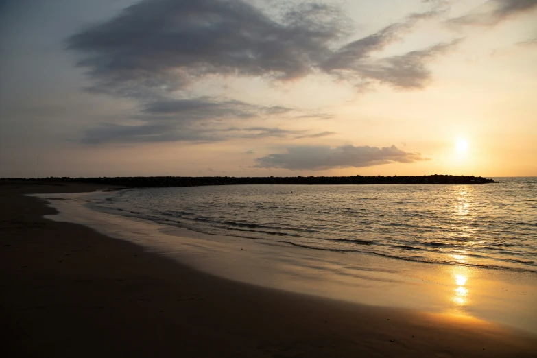 a picture of the sun going down on the ocean