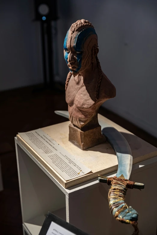 the head and arm of an egyptian bust with some writing on it