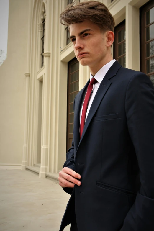 a man in a suit outside of a building