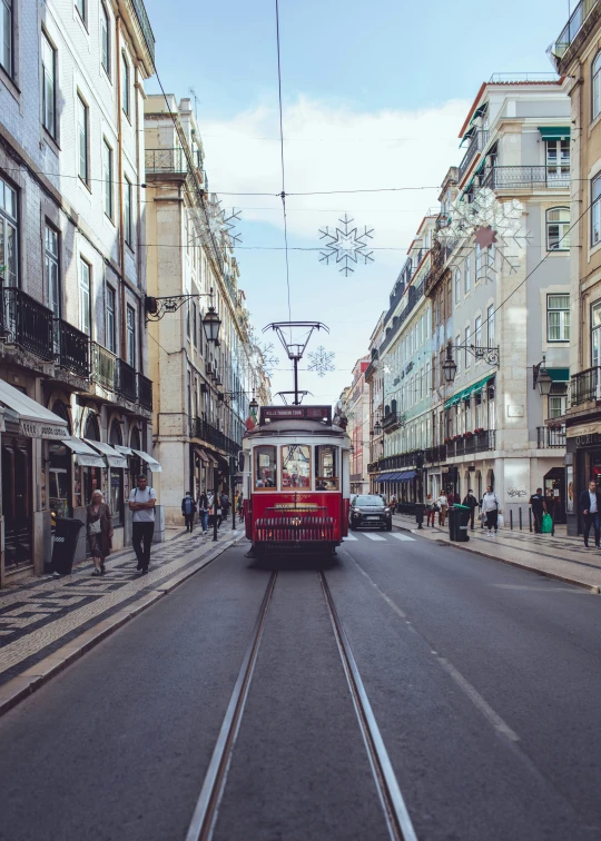 a trolley is driving through an old european street