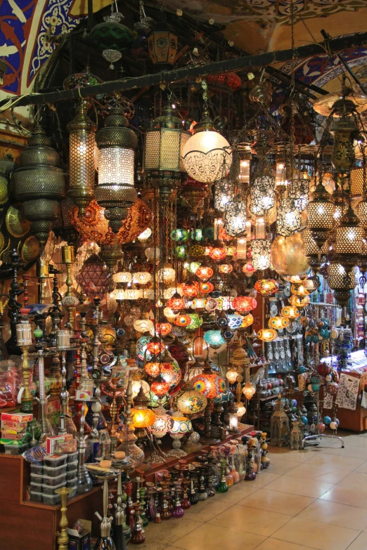 many lit lamps hanging up in a store