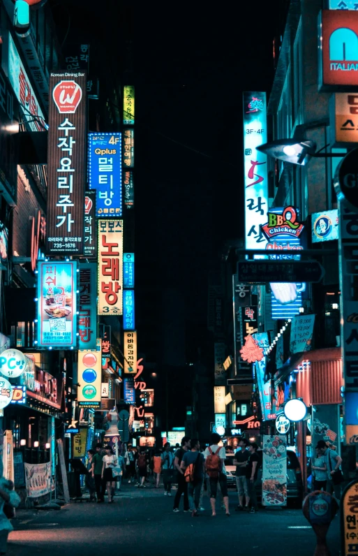 a couple people on the street at night with signs lit up