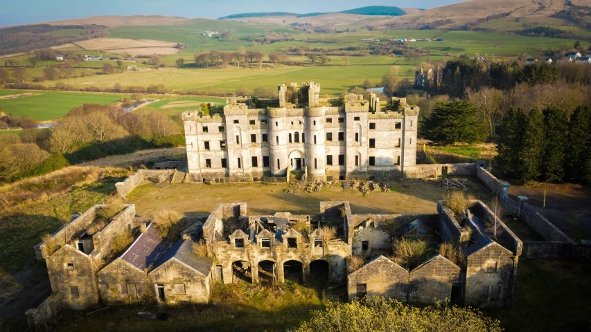 an old castle sitting on top of a green field