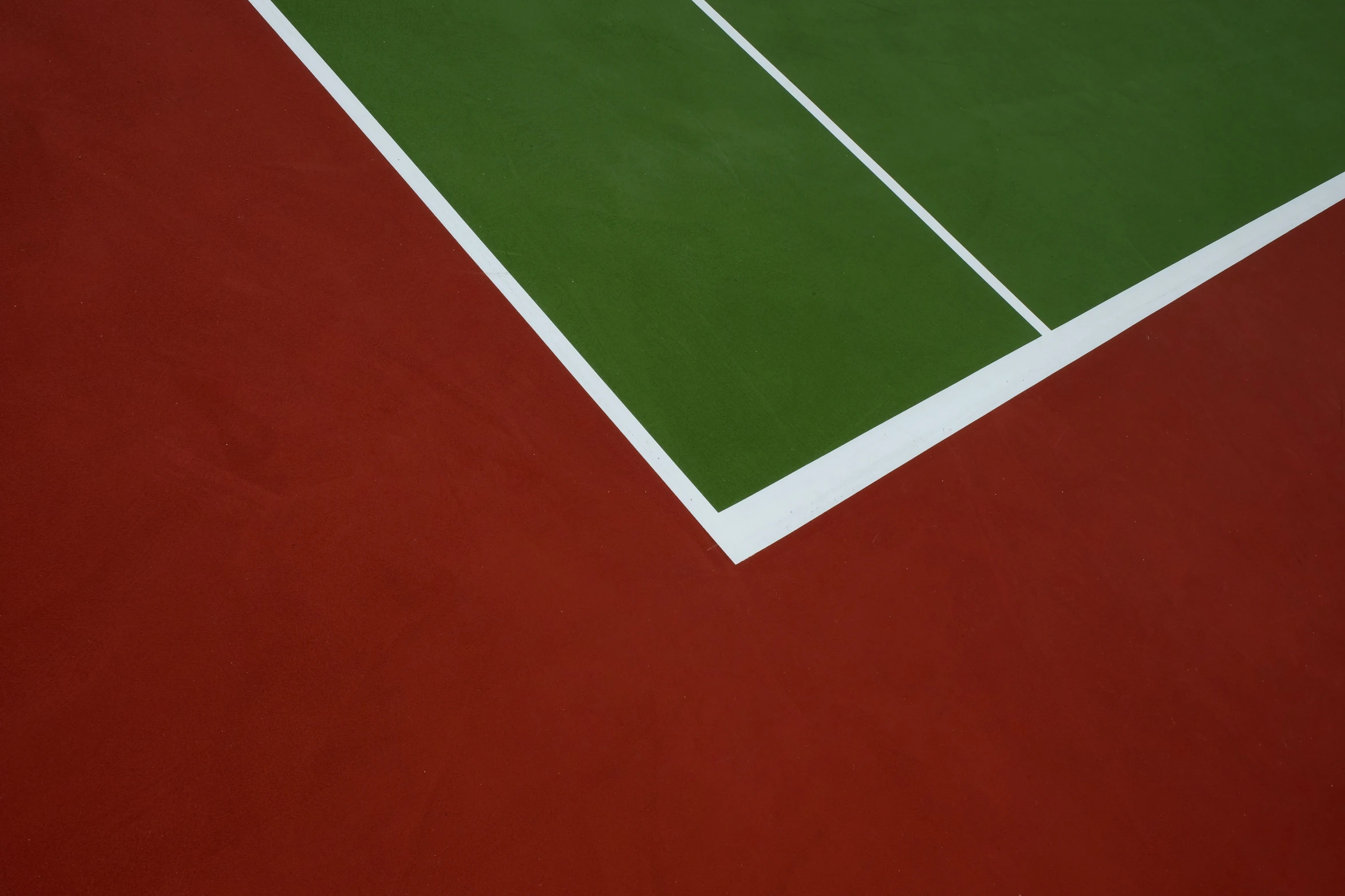 a tennis court with green and red floor