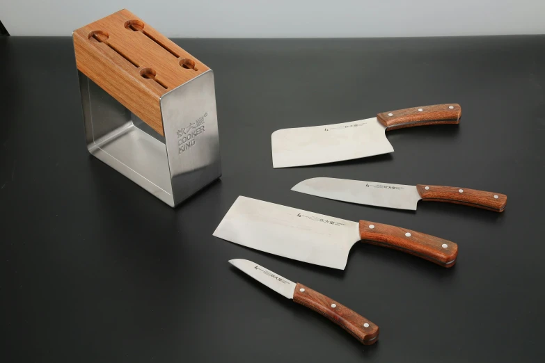 three knives are next to each other with one  board