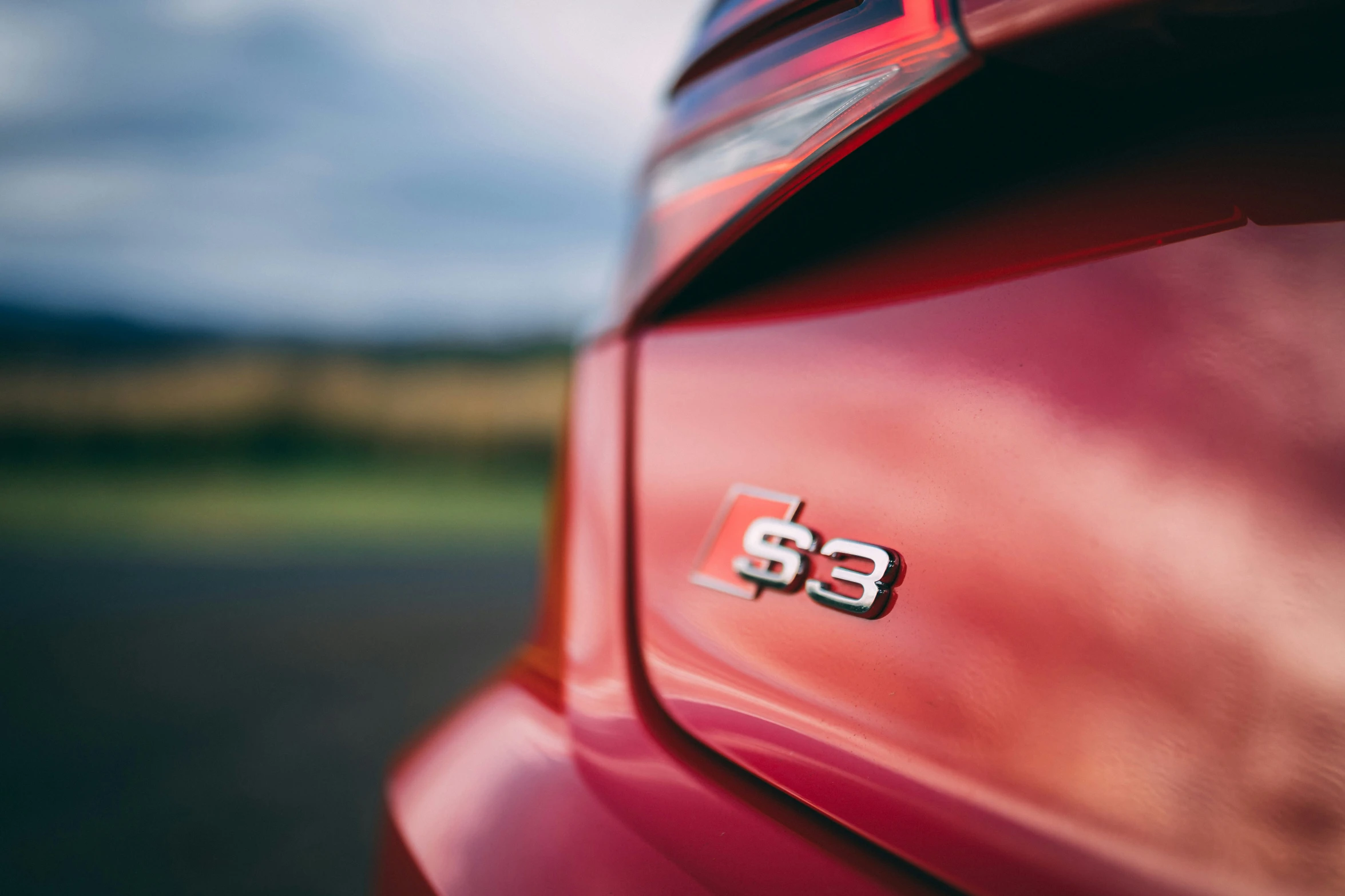 a close - up of the back end of a red sports car