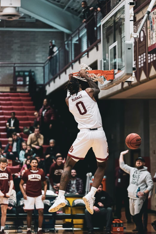 basketball player dunking the basketball at a game