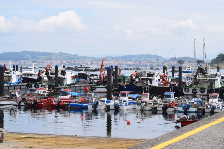 the boats are docked on the water by the boardwalk