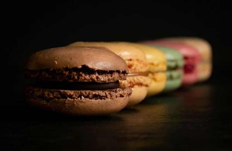 there are many macaroons in each with different colored frosting