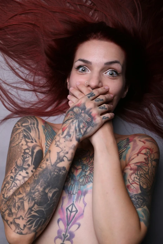 a woman has many tattoos on her body