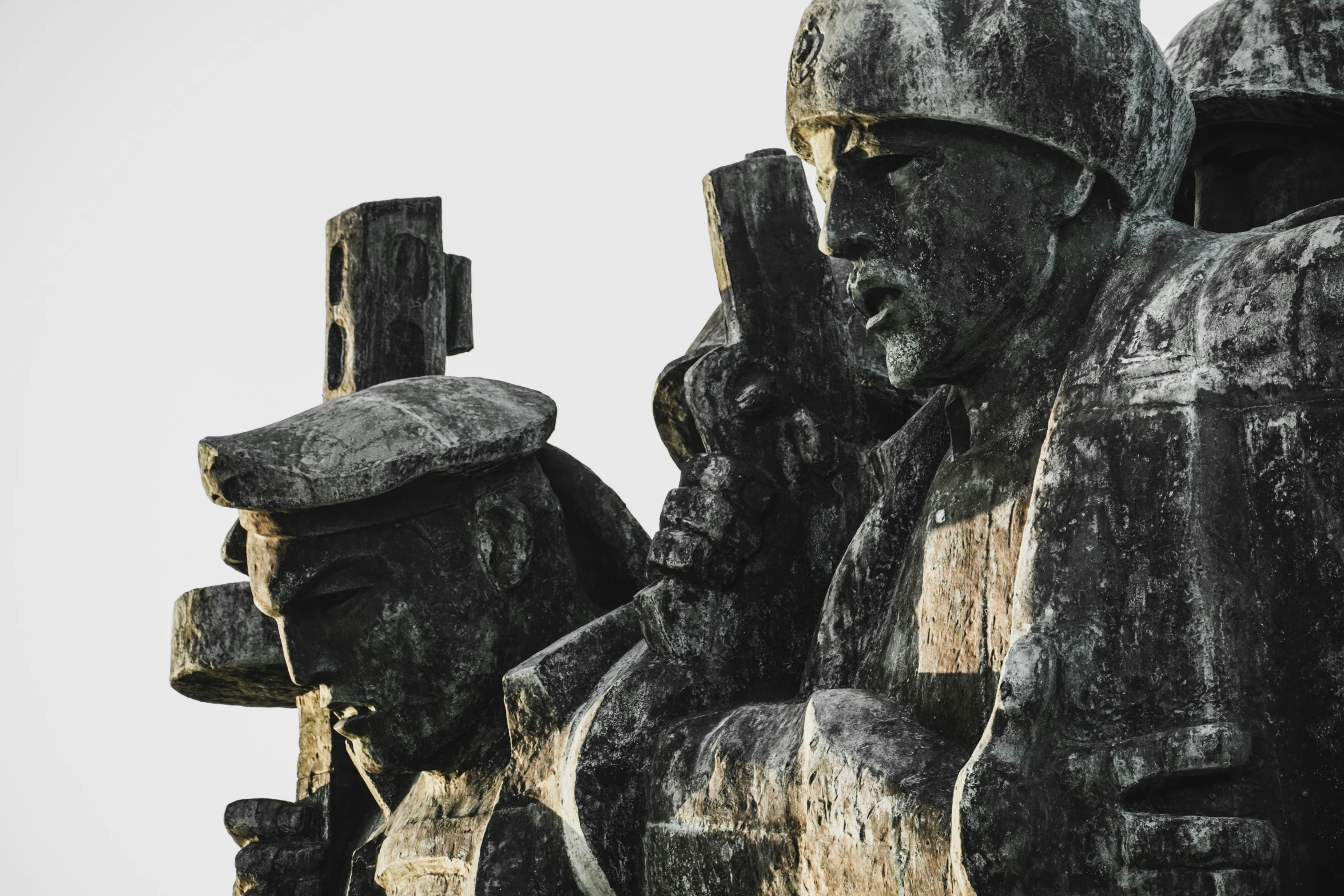 a statue depicting soldiers holding onto a cross