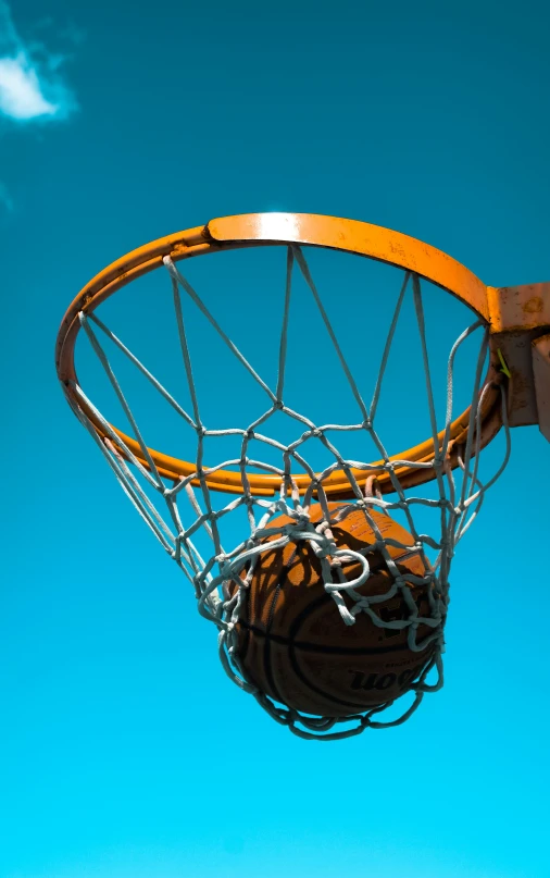 the basketball is going through a metal basket