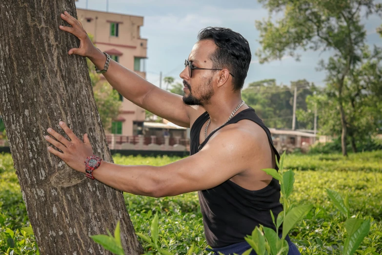 man standing by a tree looking at soing