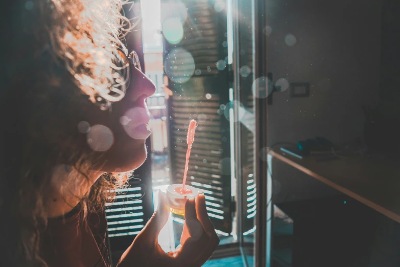 girl taking a selfie in a dark room with lights coming through the window