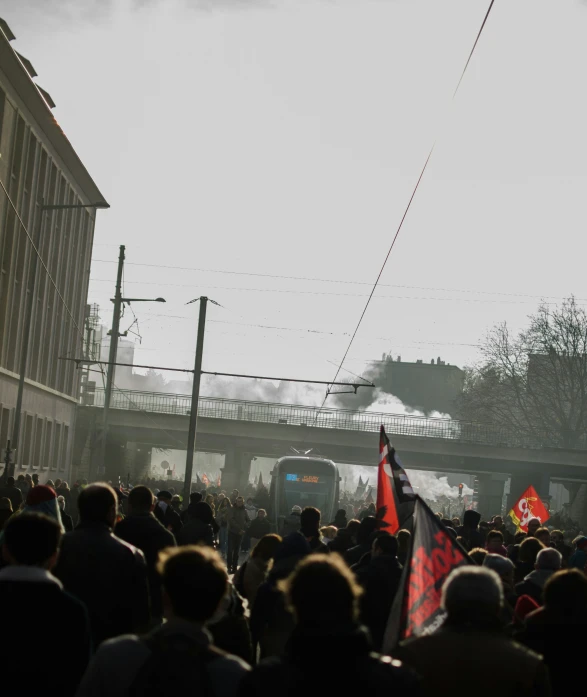 crowd of people looking toward a train crossing