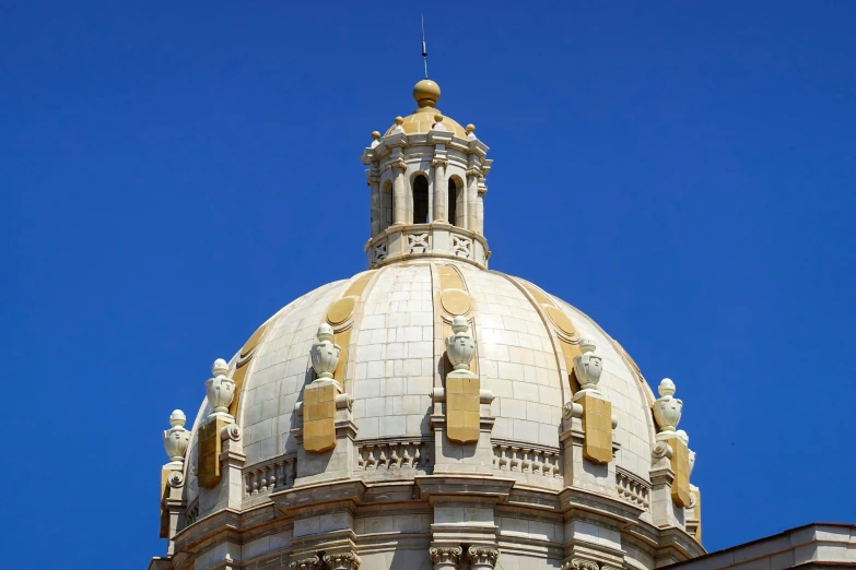 the roof of a large building with an ornate spire