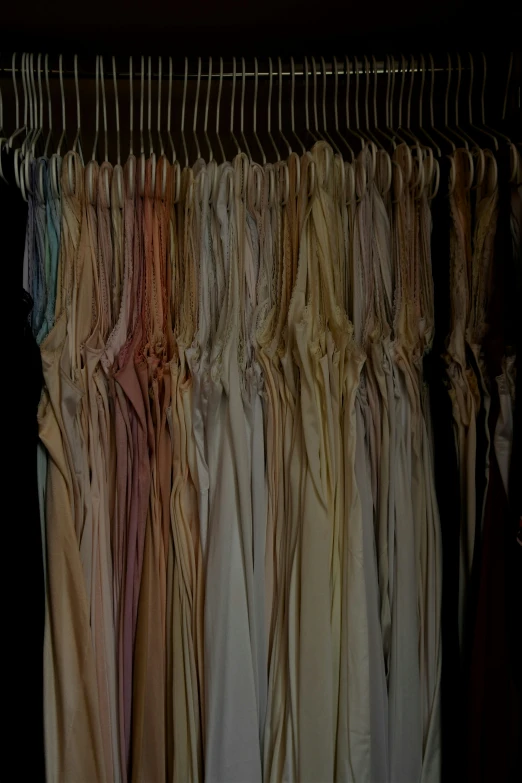 a bunch of dresses hung in a closet