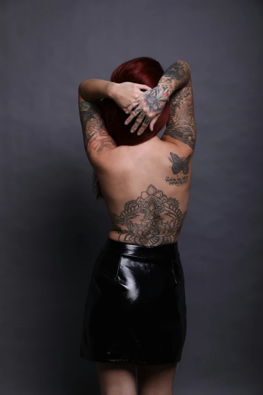an individual with many tattoos on their back