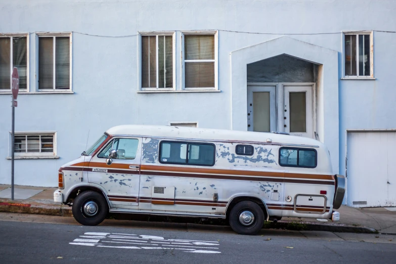 a van parked next to a white building