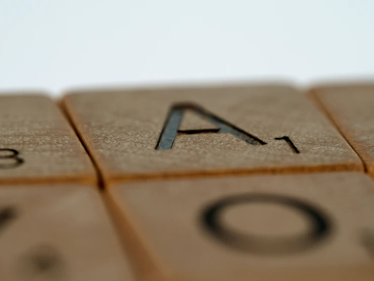 a closeup po of a letter and numbers that are written in wood