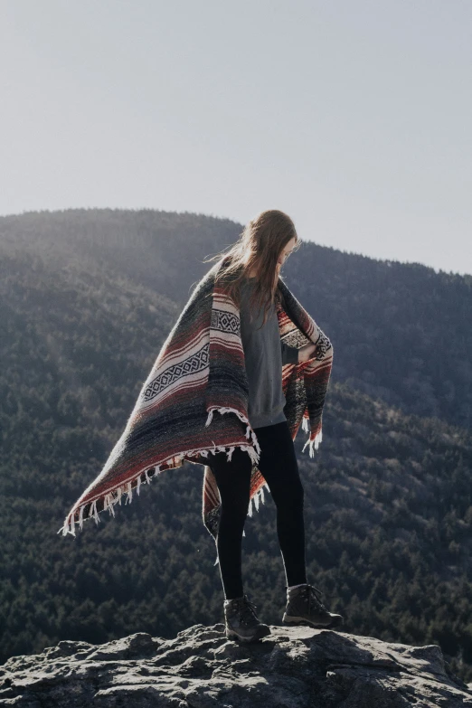 a woman holding a red, white and blue blanket