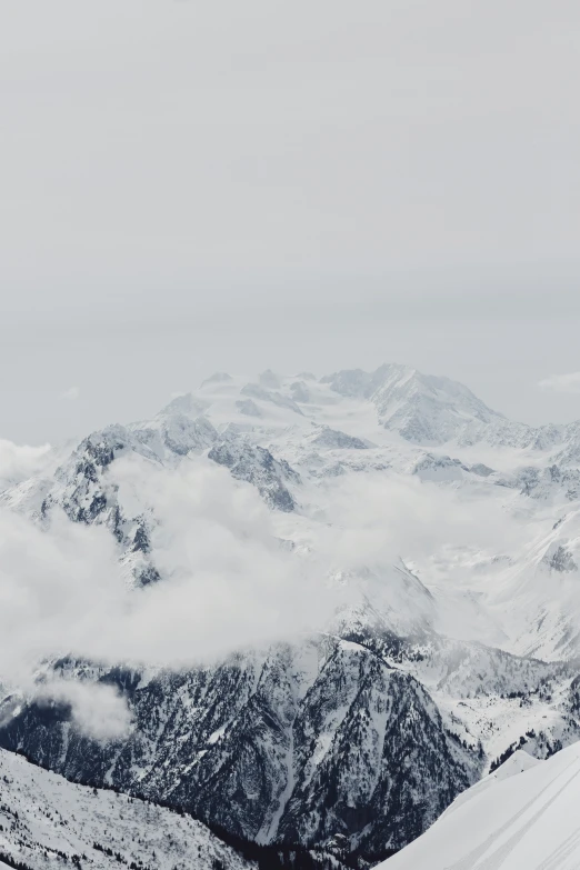 a skier is at the top of a snowy mountain