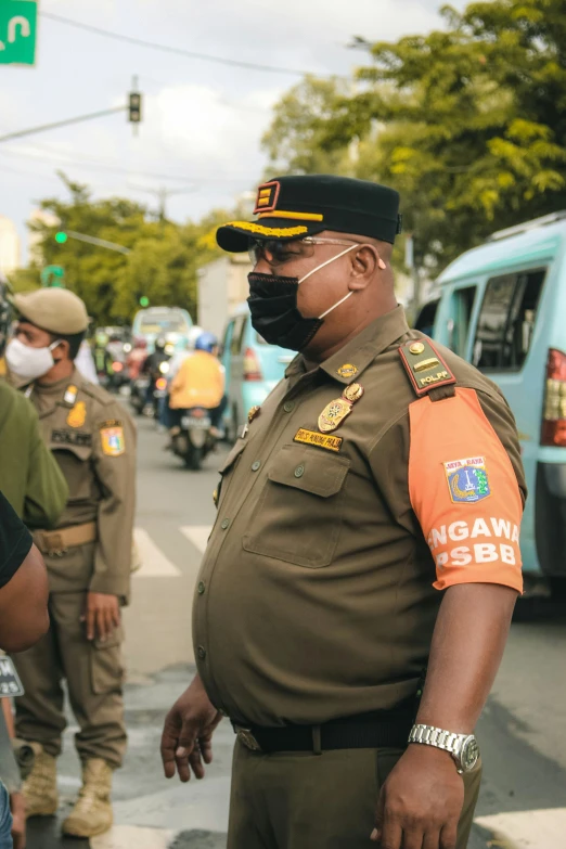 an officer standing in a street in front of several other people