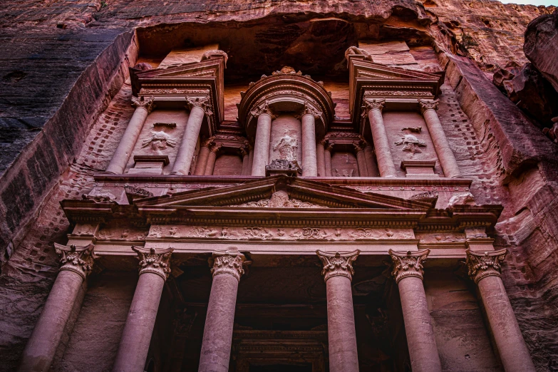 an old building has four columns that have been decorated with stone