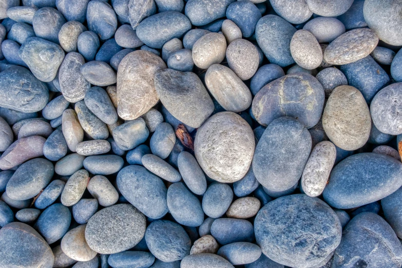 some grey rocks covered in lots of gray and white rocks