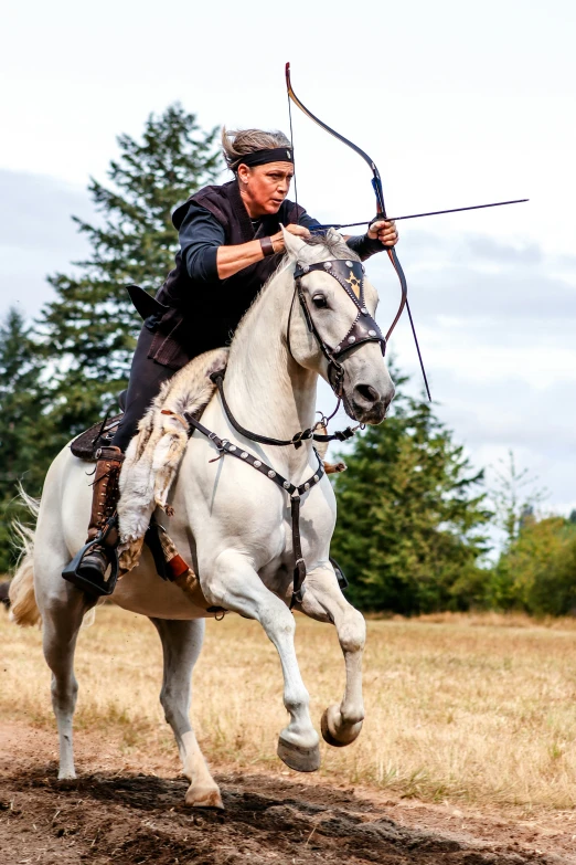 a man rides on the back of a white horse