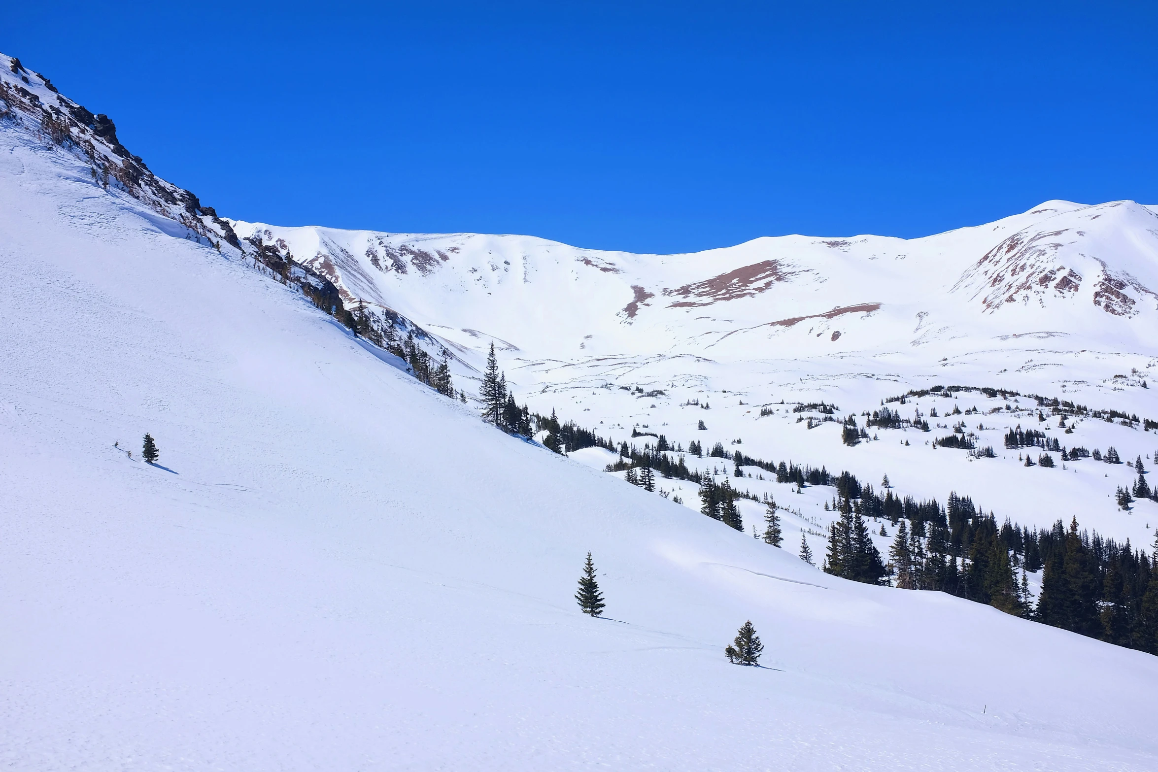 a person is skiing down a snow - covered mountain