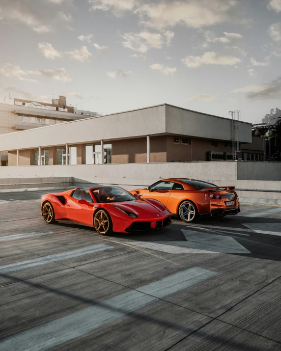 two orange sports cars parked near each other