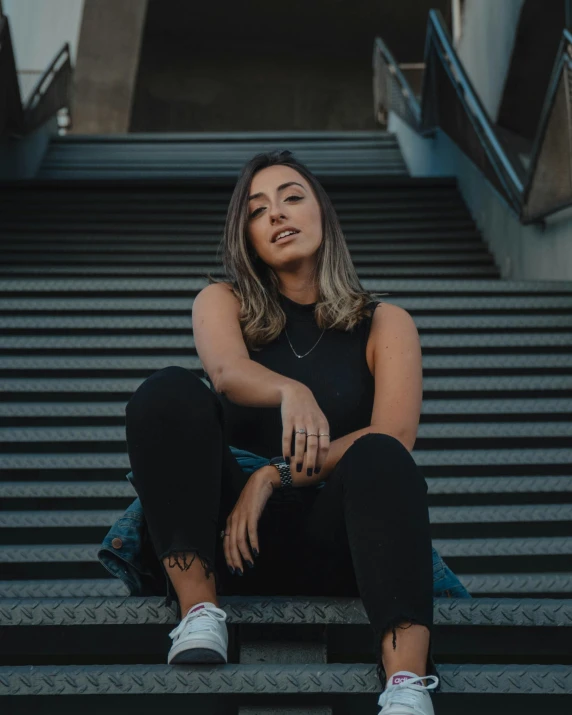 woman sitting on stairs outside the city