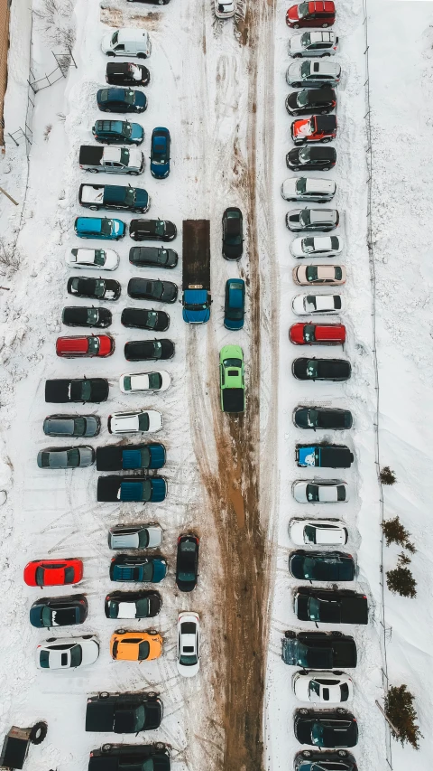 cars parked in snow with buildings in the background