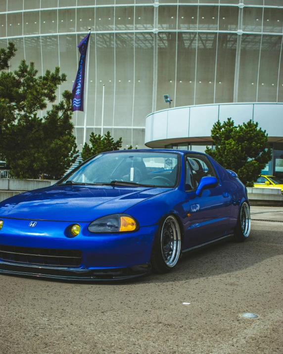 a blue car parked in front of a building