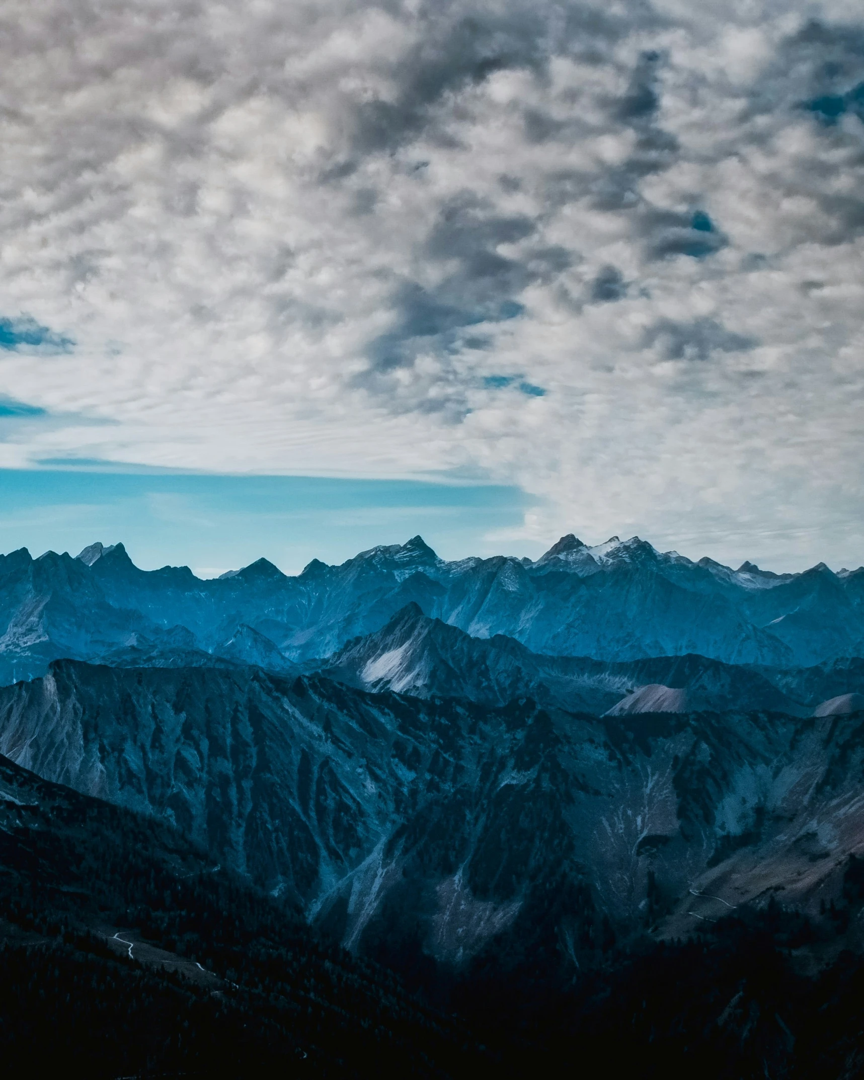 a view of the mountains with clouds in the sky