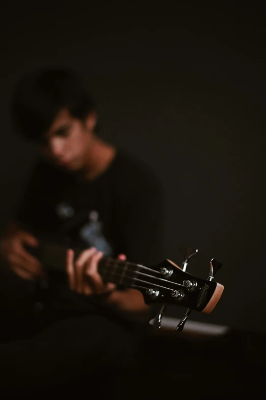 a boy with an acoustic guitar in his hands