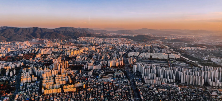 an aerial view of a city during sunset