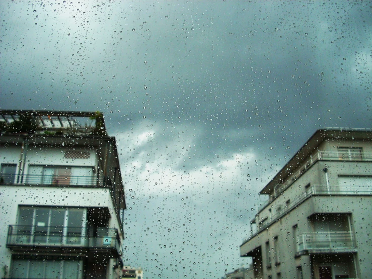 a rainy day and some buildings with the sky outside