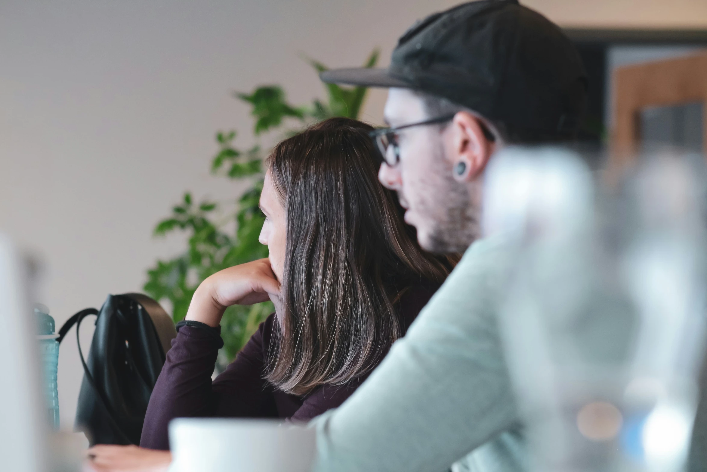 a couple sitting at a table looking into each others eyes