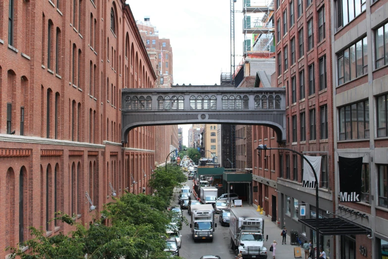 a street view with lots of traffic and tall brick buildings