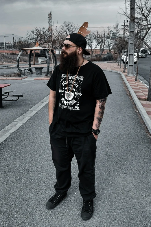 a bearded man standing in the middle of the street