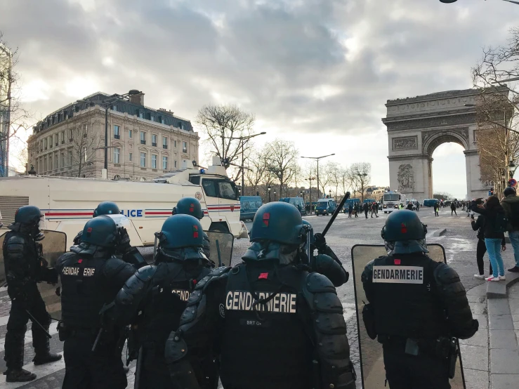 a number of people in uniform next to a fence