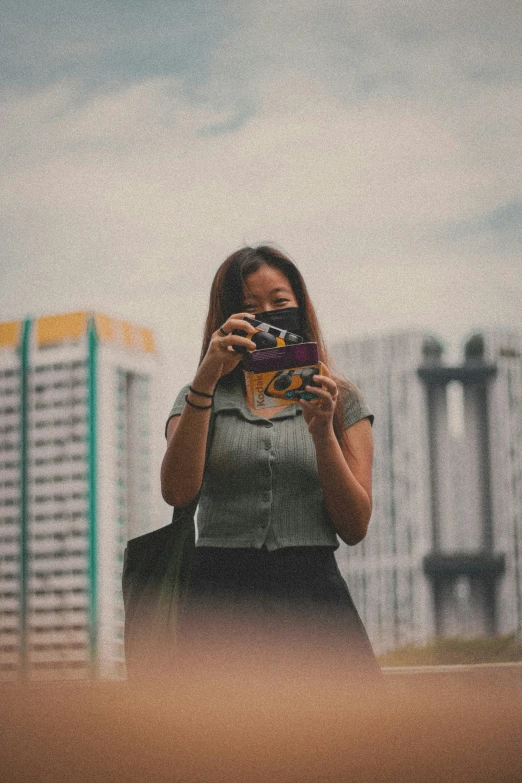 the woman is taking a po while holding her camera