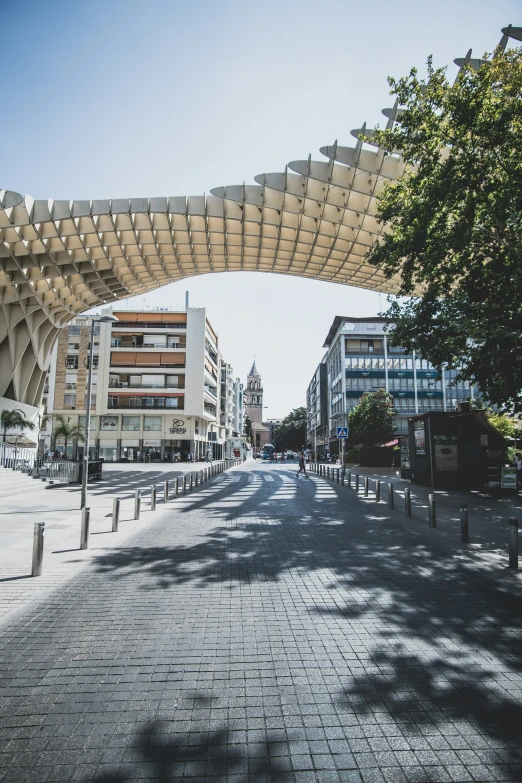 a road passing underneath a roof in a city