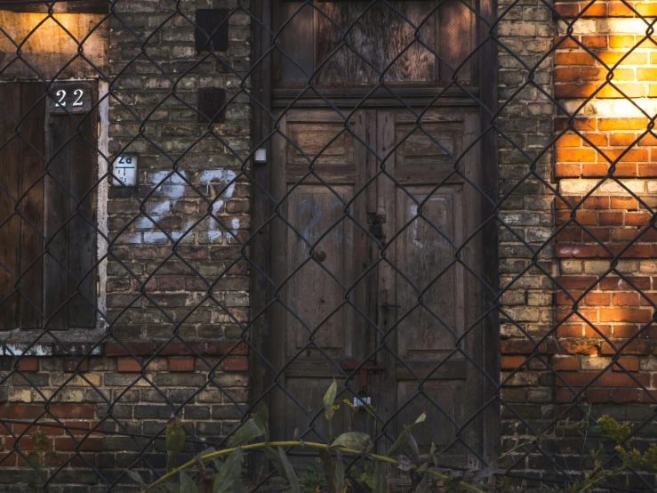 the side of an old building with a brick building behind it